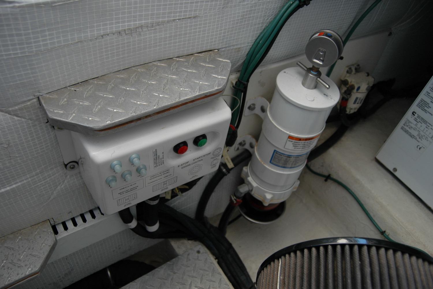 Engine compartment of a 2014 Back Cove 37 boat, featuring control panel and filter system.