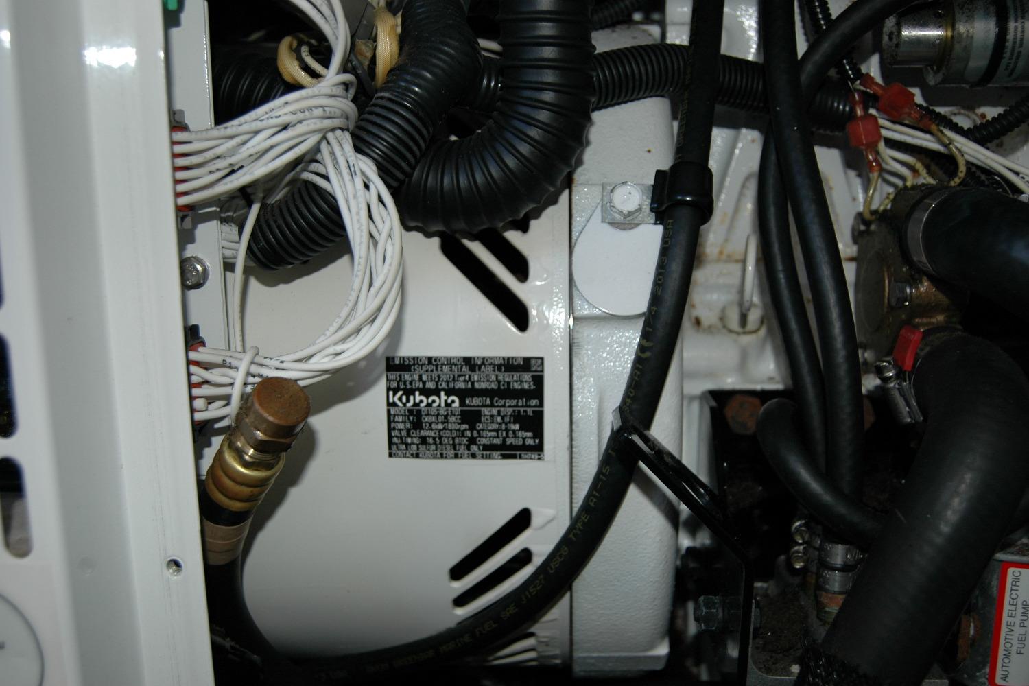 Engine compartment of a 2014 Back Cove 37 boat featuring Kubota components.