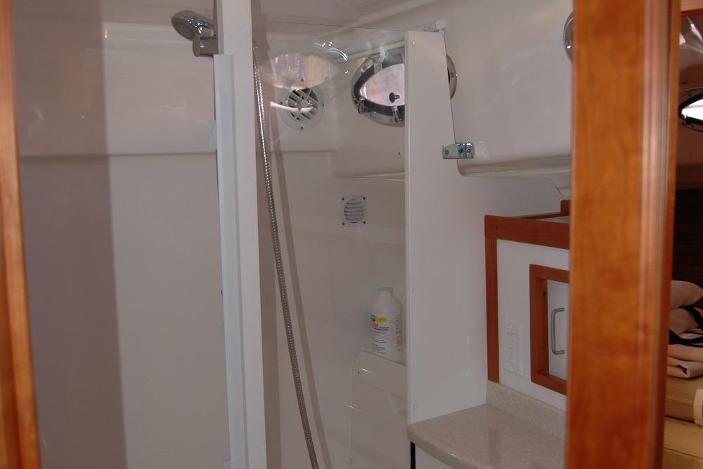 Bathroom interior of 2014 Back Cove 37 yacht, featuring shower and wooden accents.
