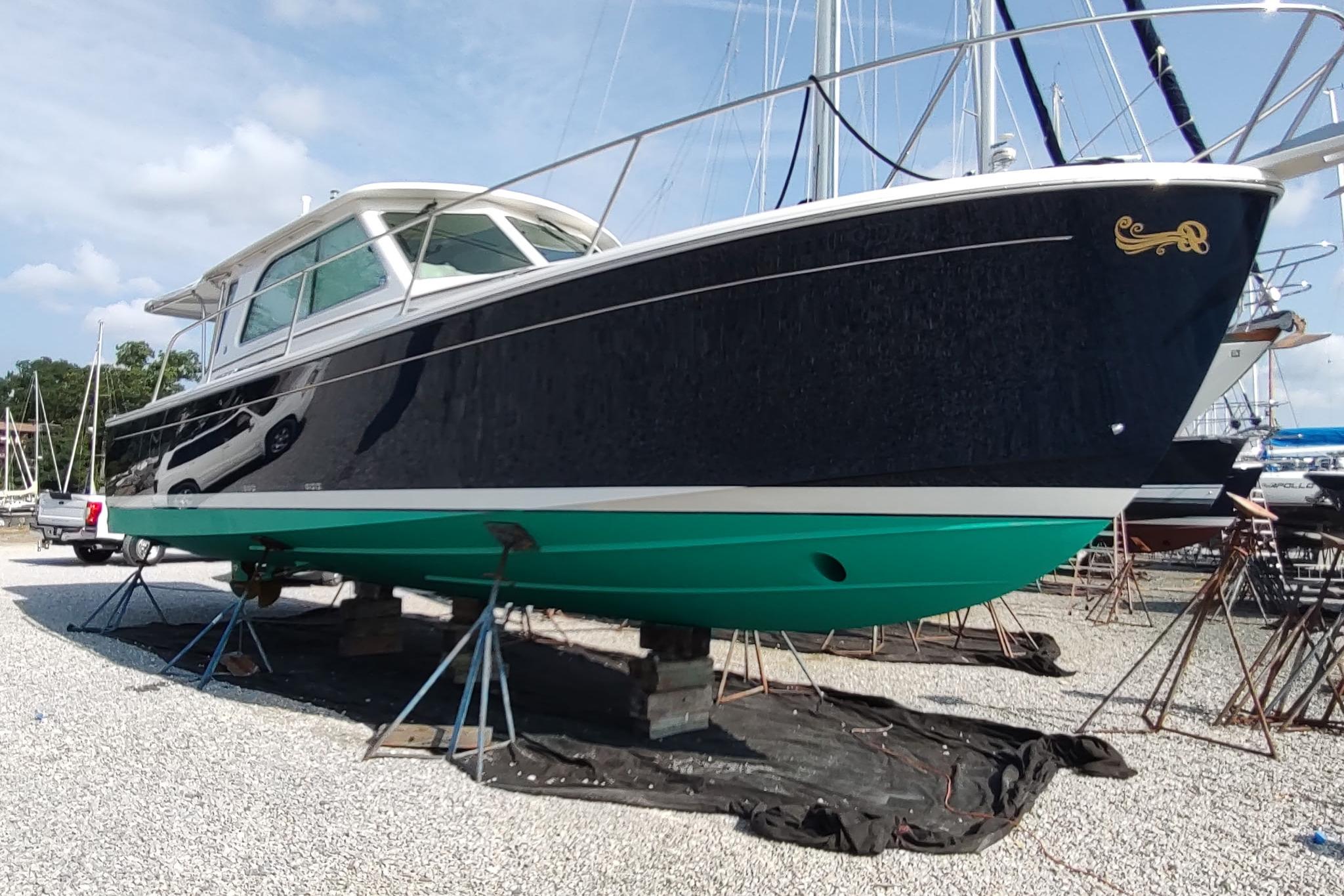 2014 Back Cove 37 boat on stands in a marina, side view.