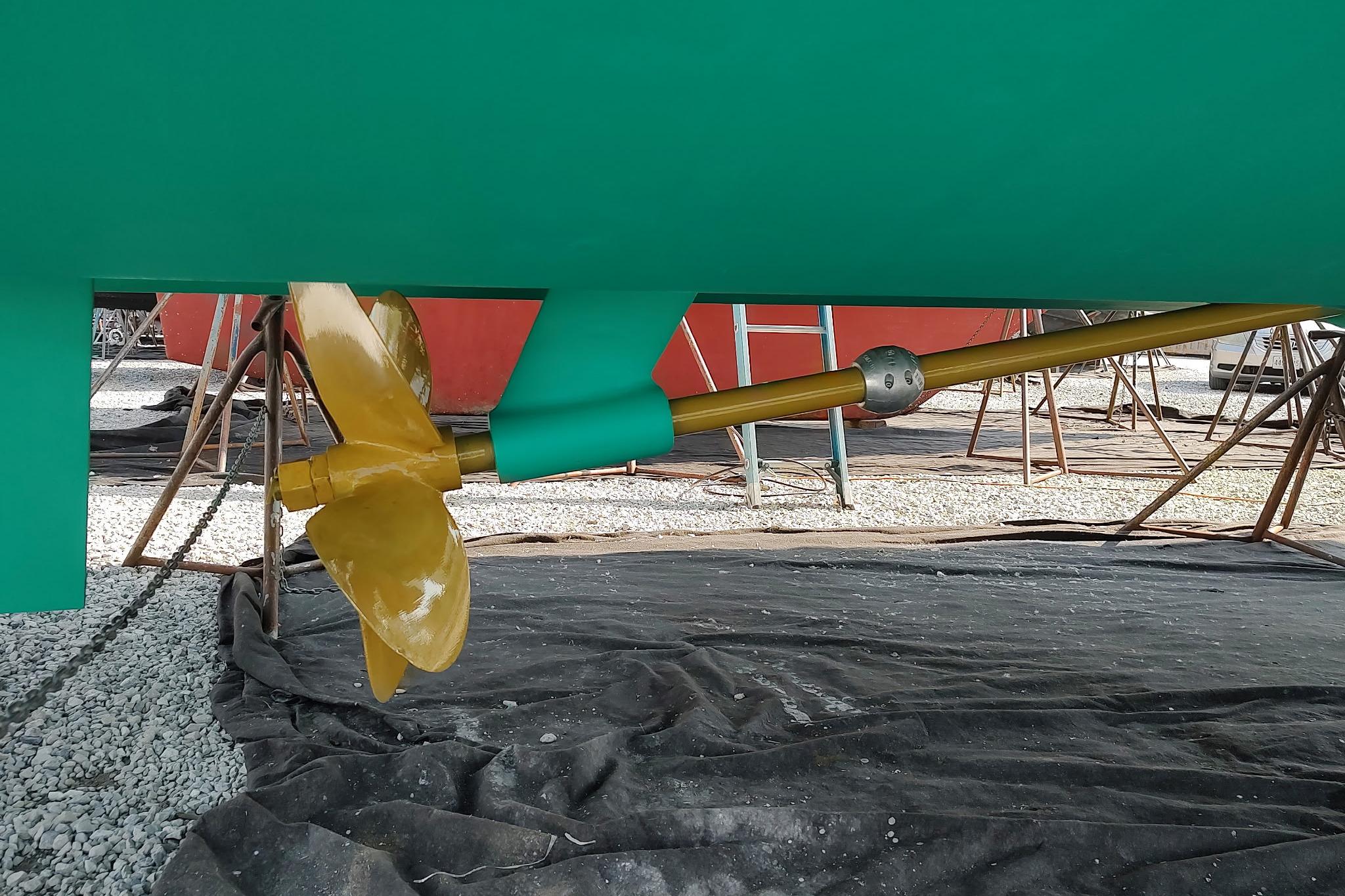 2014 Back Cove 37 boat propeller and shaft on display in a shipyard.