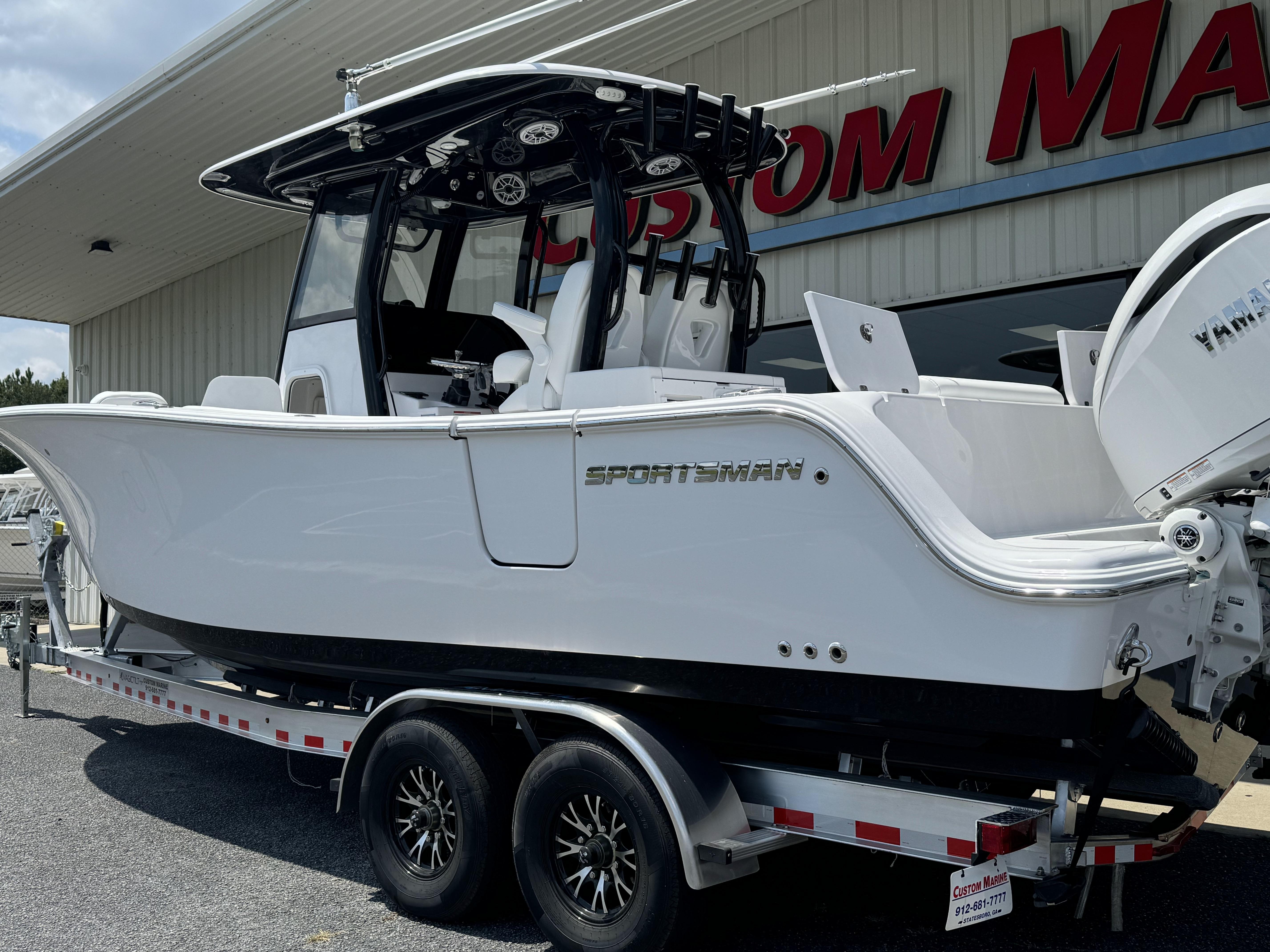2025 Sportsman Open 282 Center Console boat on trailer outside dealership.