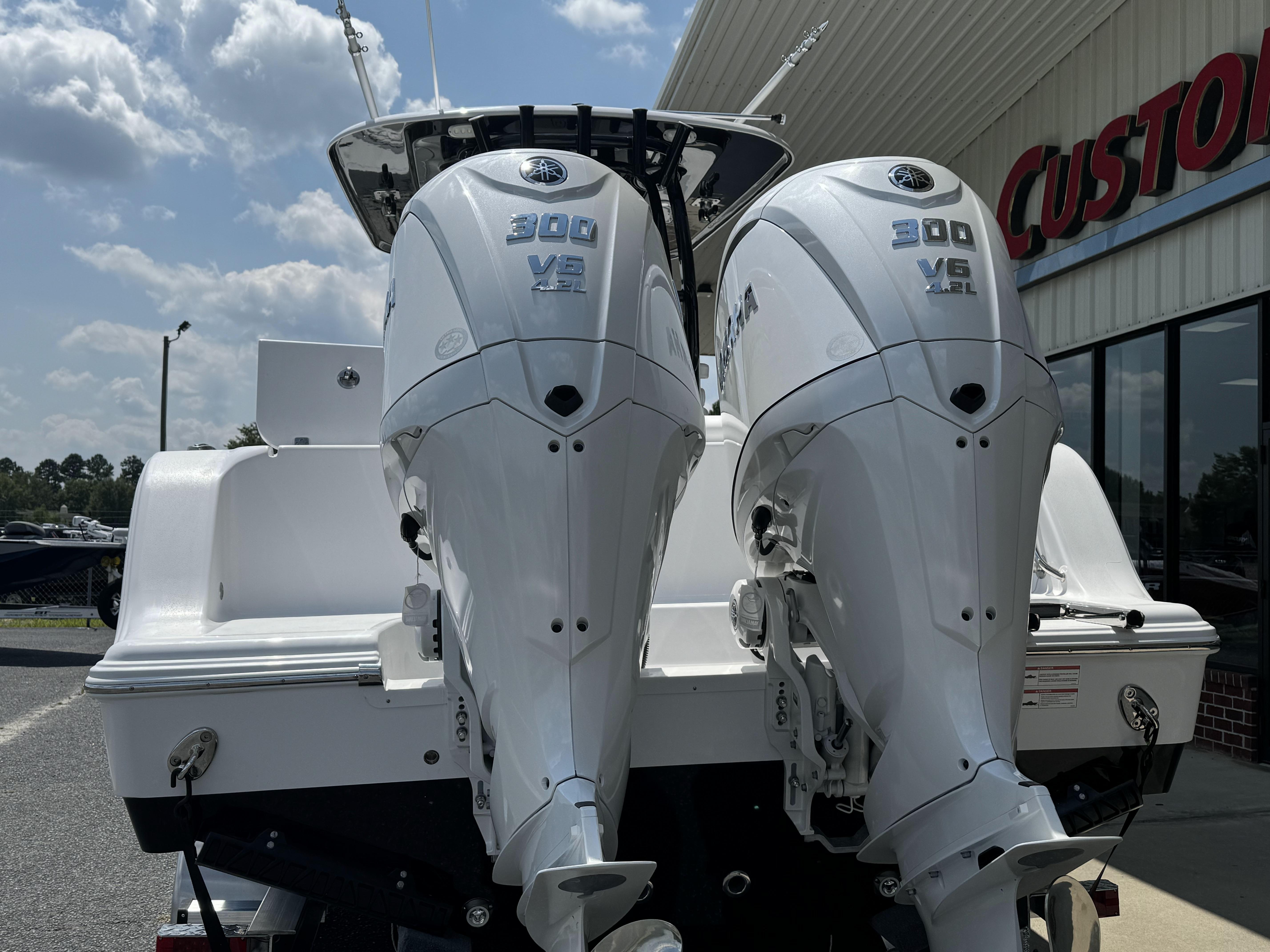 2025 Sportsman Open 282 Center Console with twin 300 V6 engines at a dealership.
