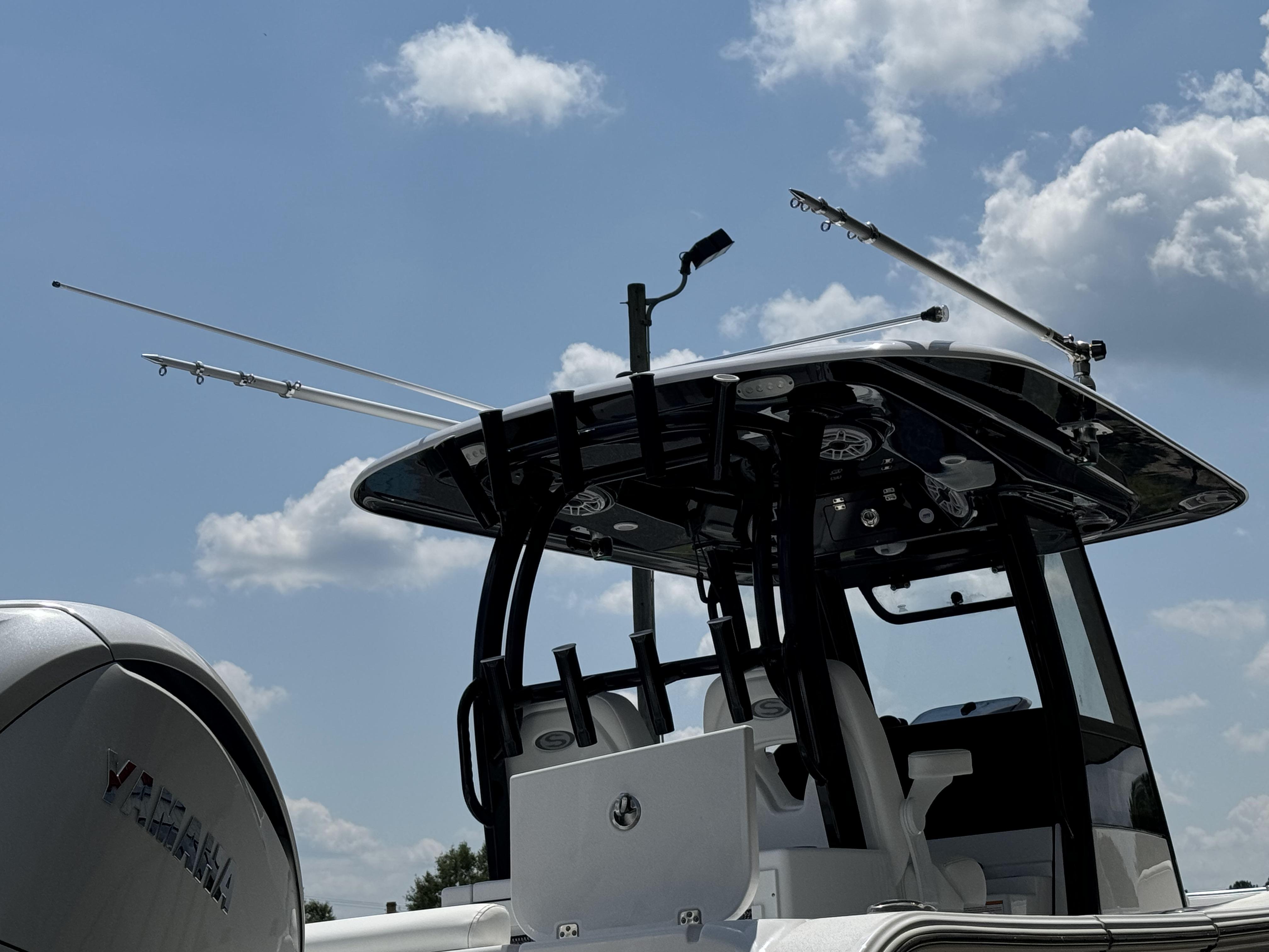 2025 Sportsman Open 282 Center Console boat under a cloudy sky.