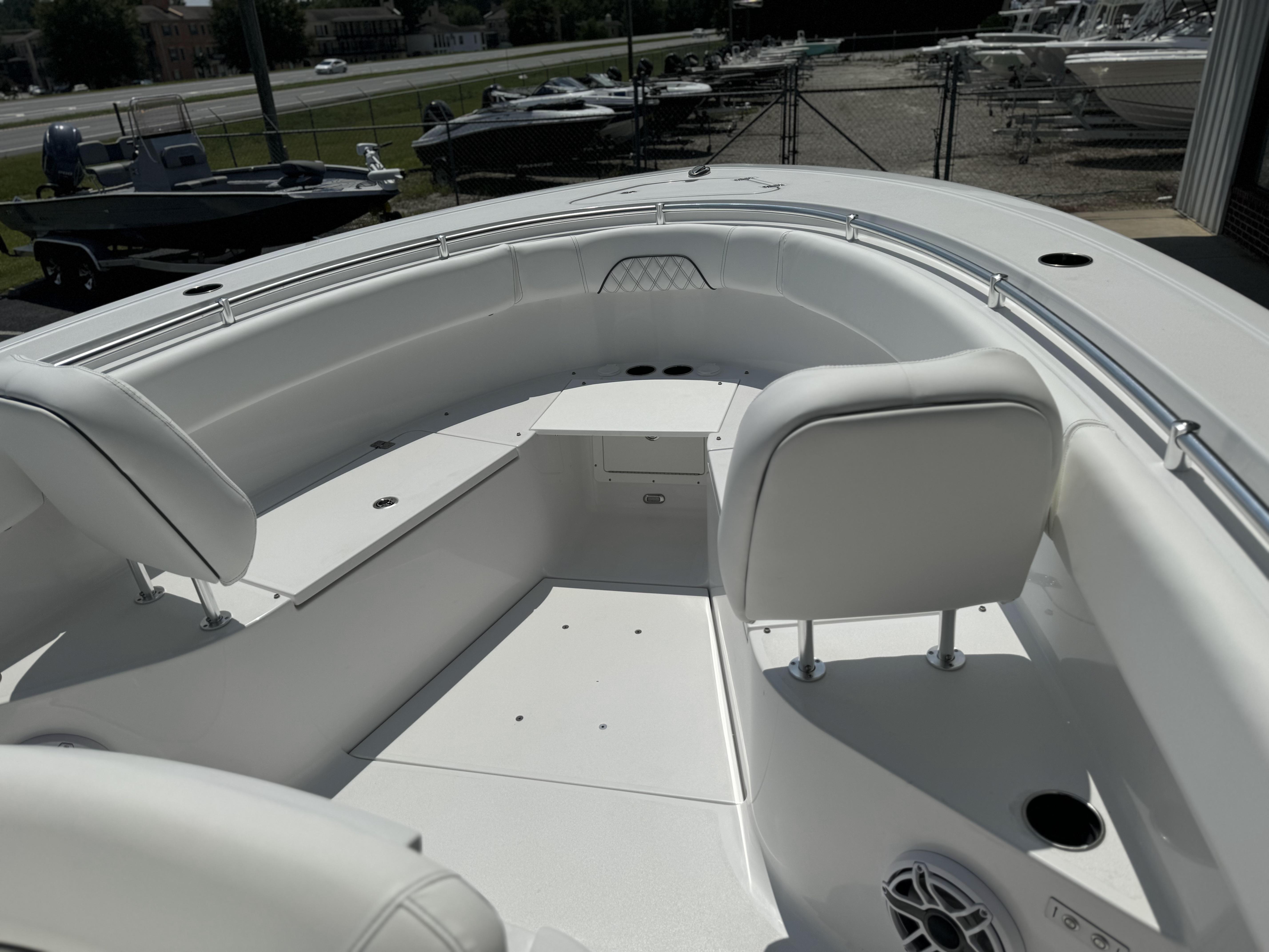 2025 Sportsman Open 282 Center Console boat interior with white seating and spacious deck.