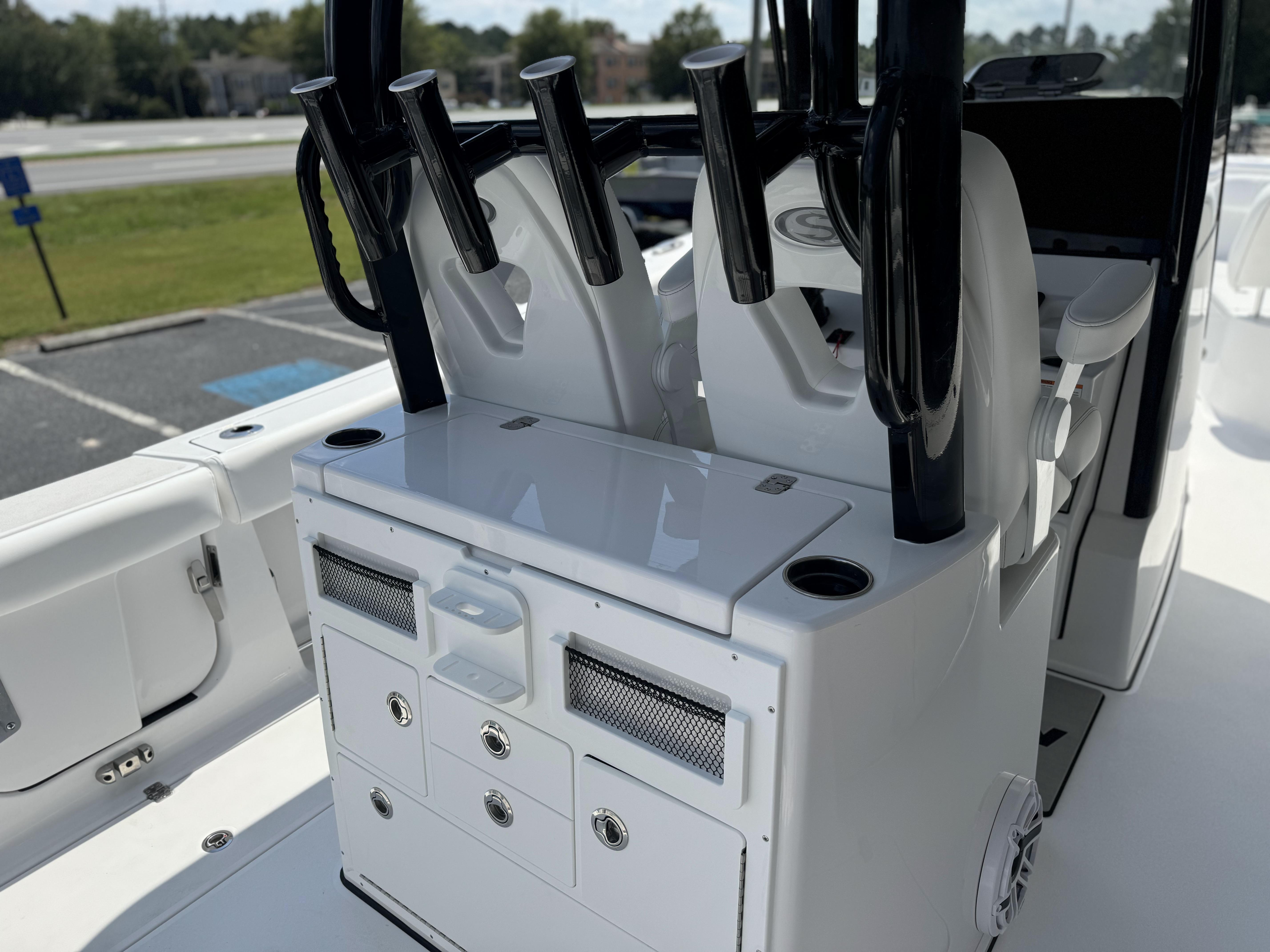 2025 Sportsman Open 282 Center Console boat interior with rod holders and storage compartments.