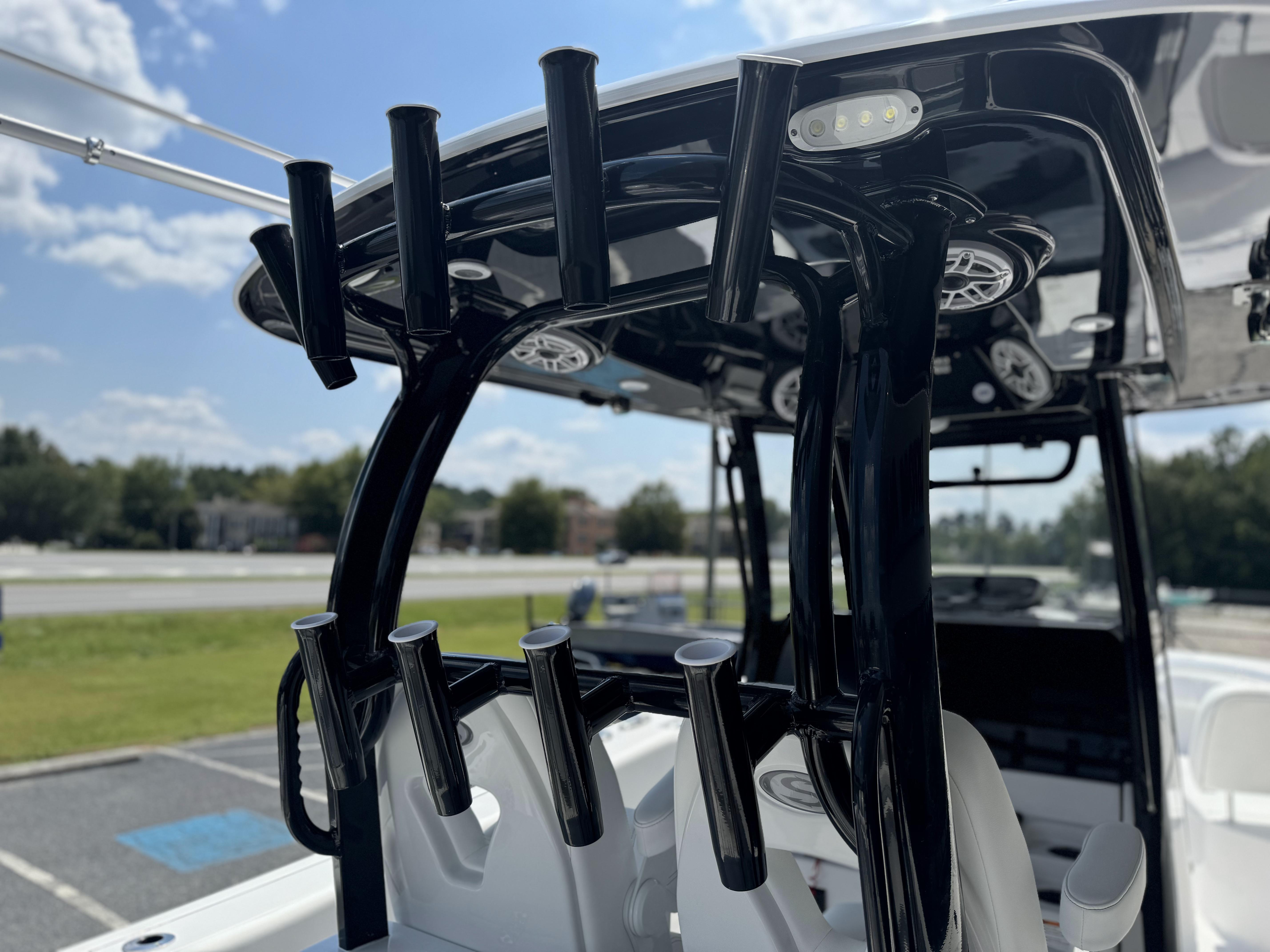 2025 Sportsman Open 282 Center Console with rod holders and speakers under a sunny sky.
