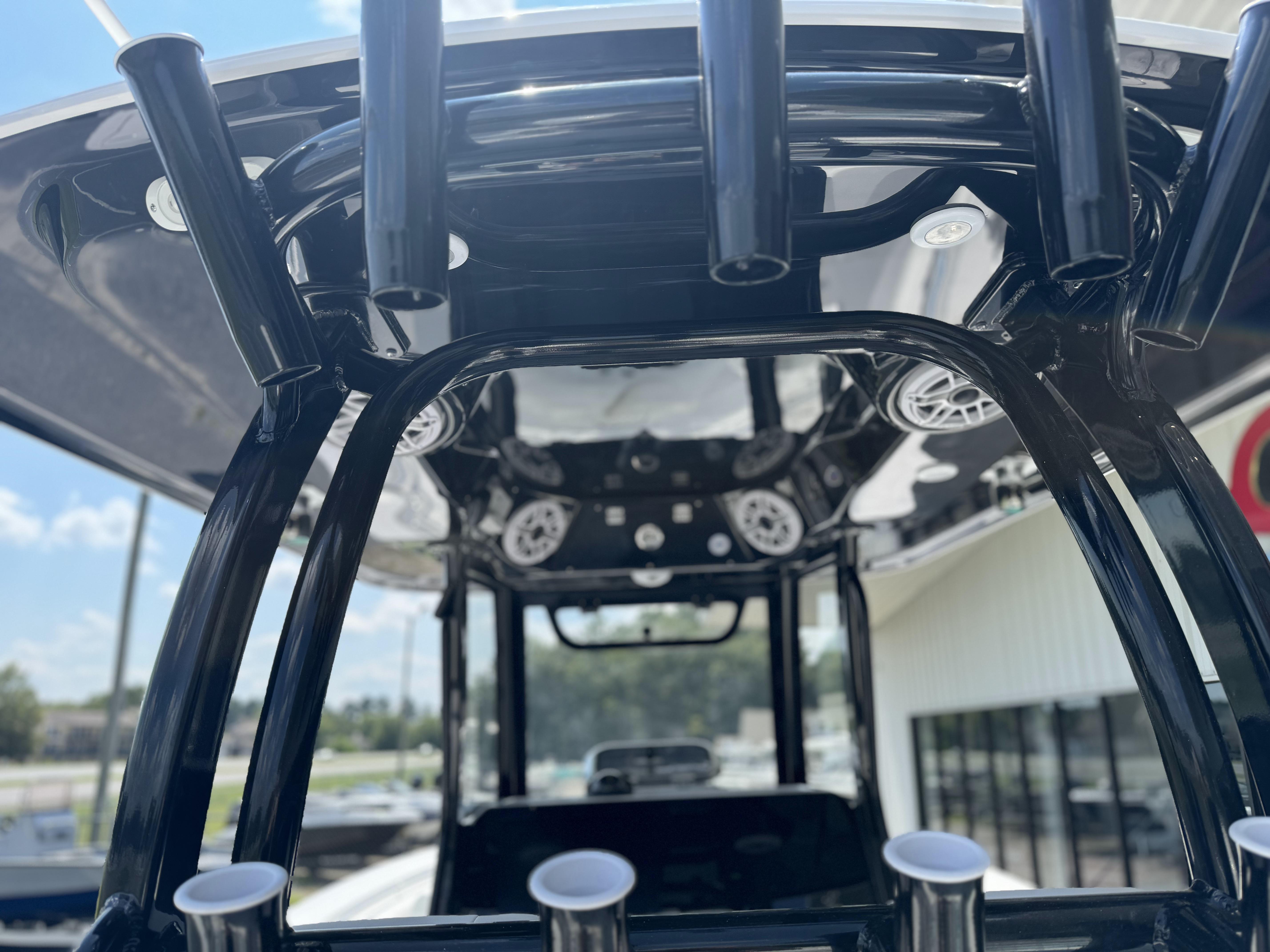 2025 Sportsman Open 282 Center Console boat interior with rod holders and speakers.