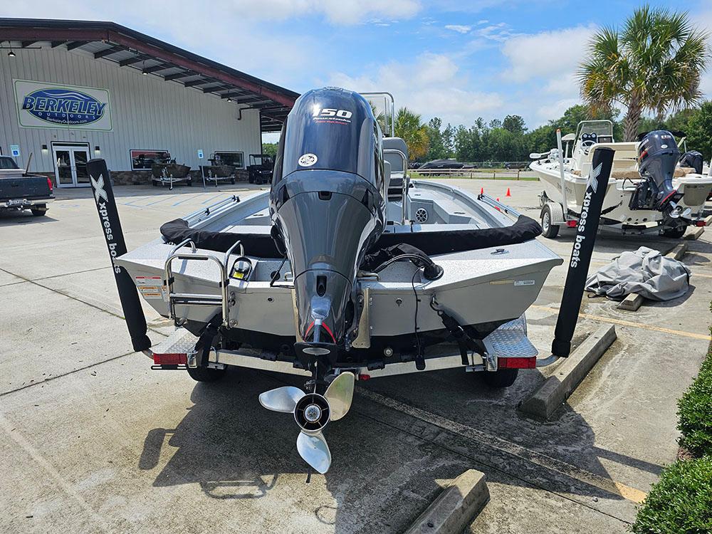 2023 Xpress H20B boat with powerful outboard motor, parked at a dealership.