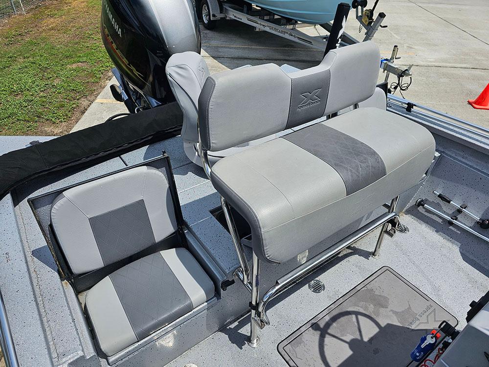 2023 Xpress H20B boat interior with gray seating and steering wheel.