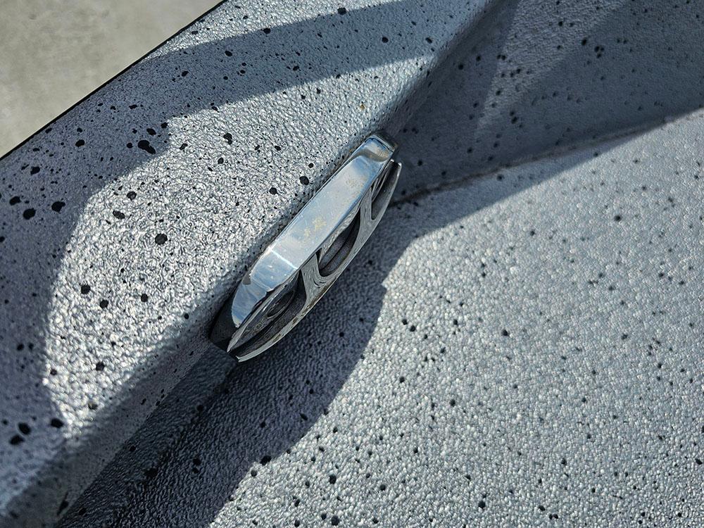2023 Xpress H20B boat detail with speckled gray surface and metal fitting.