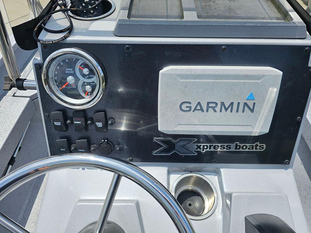 2023 Xpress H20B boat dashboard with Garmin display and steering wheel.