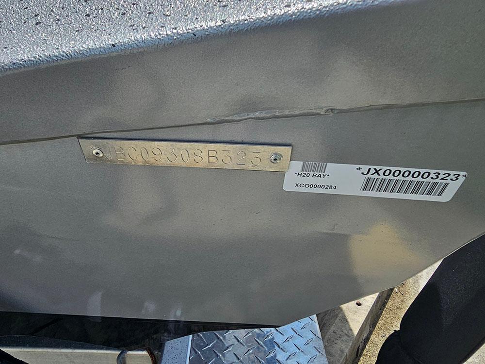 2023 Xpress H20B boat identification plate and barcode on metallic surface.