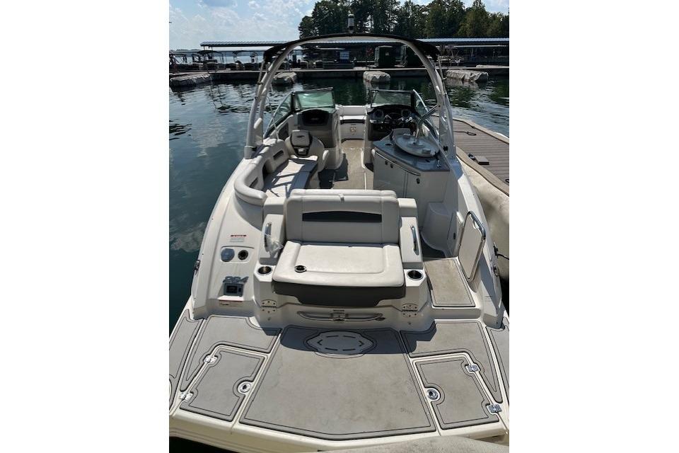 2016 Chaparral 264 Sunesta boat interior with seating and helm, docked at marina.