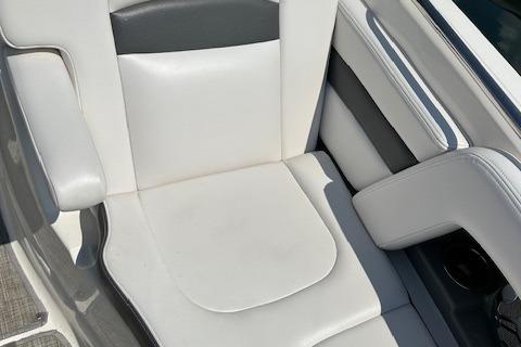 2016 Chaparral 264 Sunesta boat seat, white and gray upholstery, close-up view.