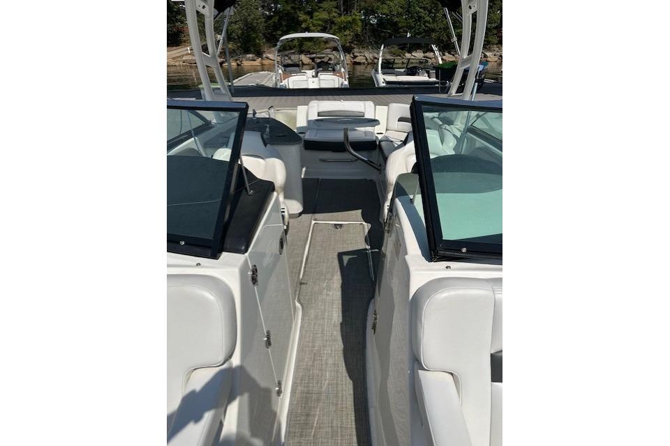 2016 Chaparral 264 Sunesta boat interior with white seating and glass windshields.