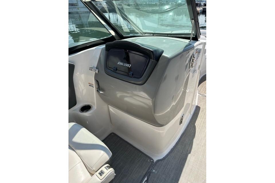 2016 Chaparral 264 Sunesta boat interior with storage compartment and seating.