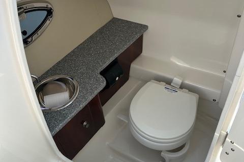 2016 Chaparral 264 Sunesta boat bathroom with sink and toilet.