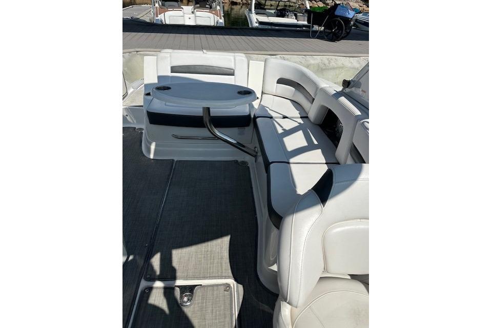 2016 Chaparral 264 Sunesta boat interior with white seating and table.