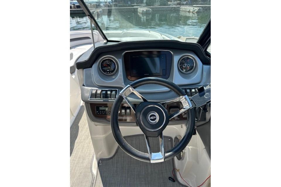 2016 Chaparral 264 Sunesta boat dashboard with steering wheel and controls.