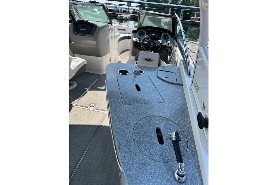 2016 Chaparral 264 Sunesta boat interior with steering wheel and seating area.