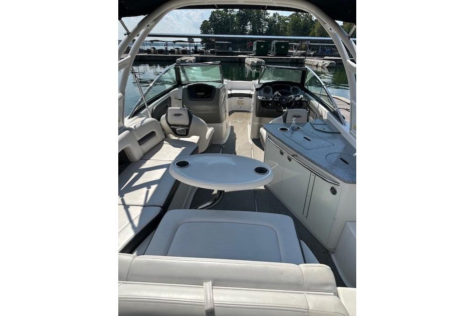 2016 Chaparral 264 Sunesta boat interior with seating and helm, docked at marina.