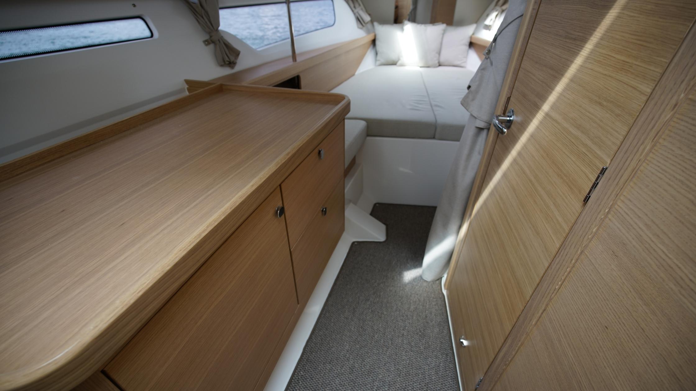 Nimbus-Weekender 11 #60 2025-In-Stock 2025 Nimbus W11 #60 FL-US-Interior of 2025 Nimbus Weekender 11 #60, featuring cozy cabin with bed and wooden cabinetry.-9829239 | Thumbnail