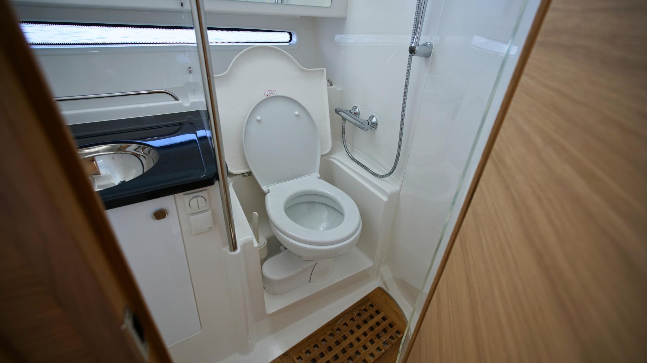Nimbus-Weekender 11 #60 2025-In-Stock 2025 Nimbus W11 #60 FL-US-Compact bathroom in 2025 Nimbus Weekender 11 #60 boat, featuring toilet and shower.-9829239 | Thumbnail