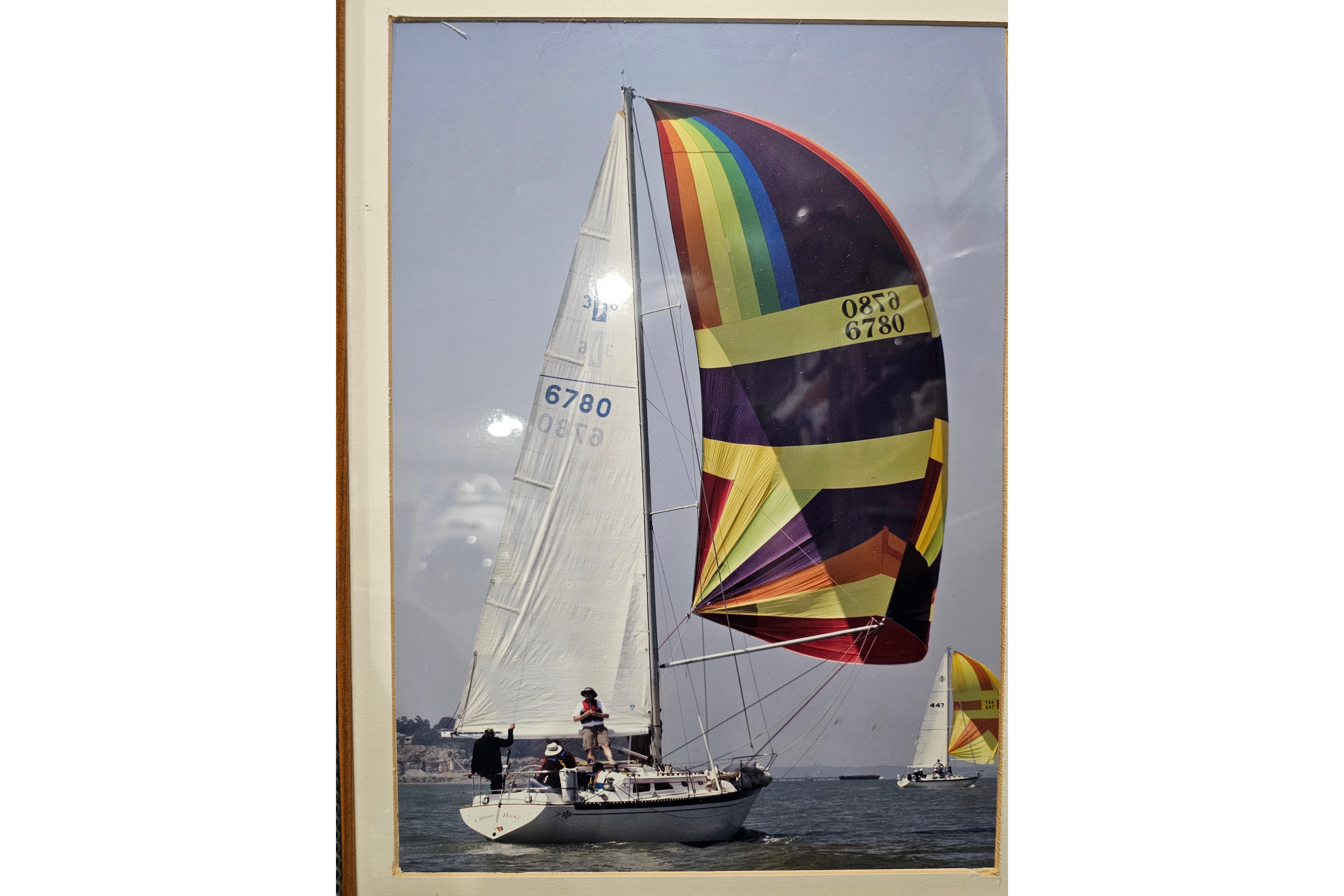 1978 Islander 36 sailboat with colorful spinnaker sailing on open water.