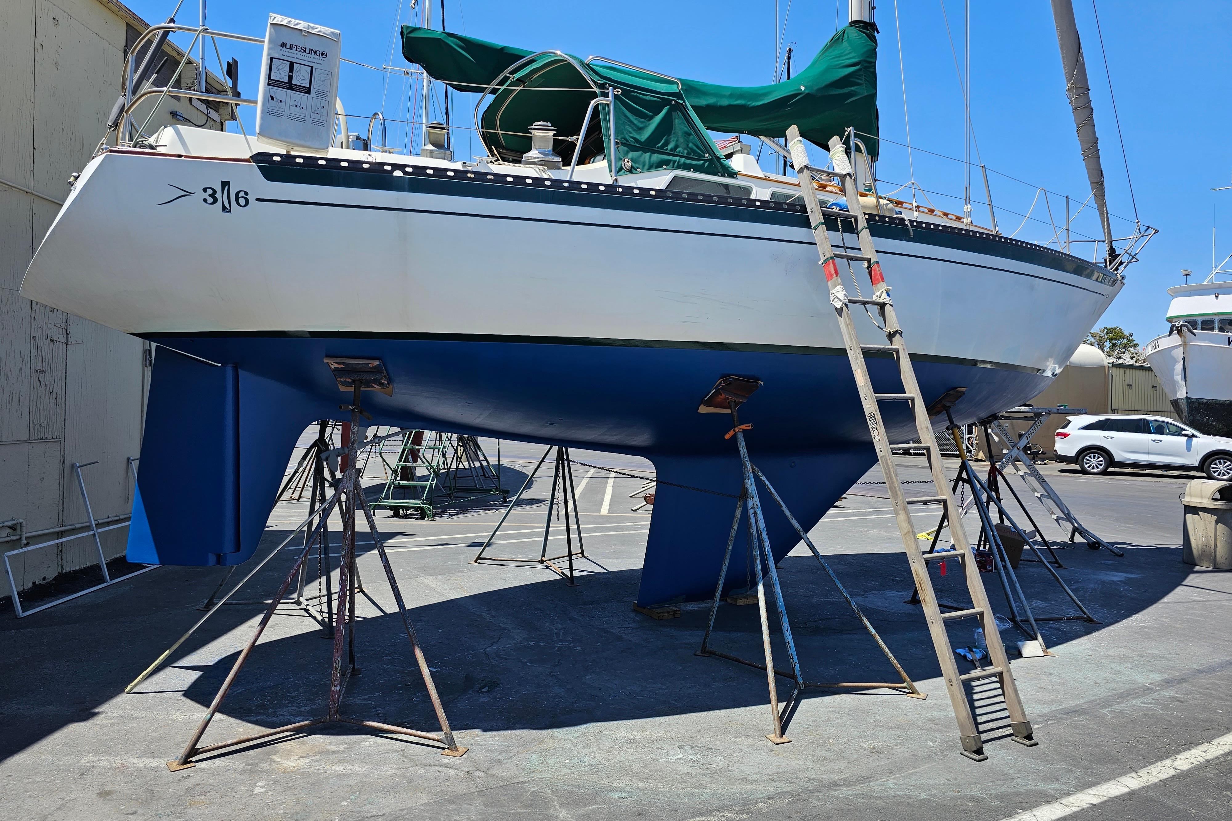 1978 Islander 36 sailboat on stands, undergoing maintenance in a boatyard.