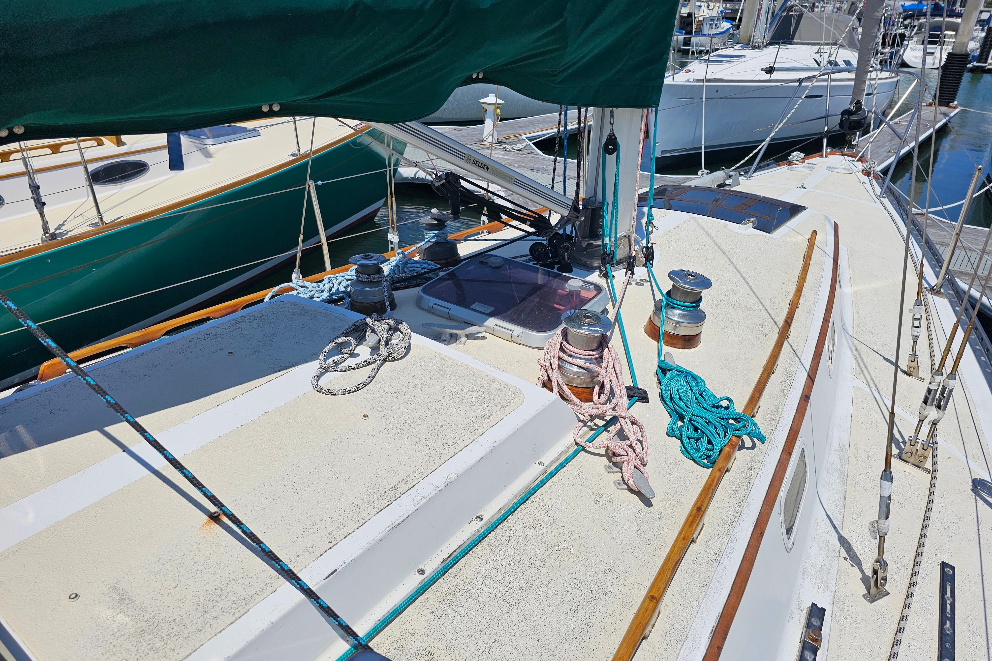 1978 Islander 36 sailboat deck with ropes and winches in a marina.