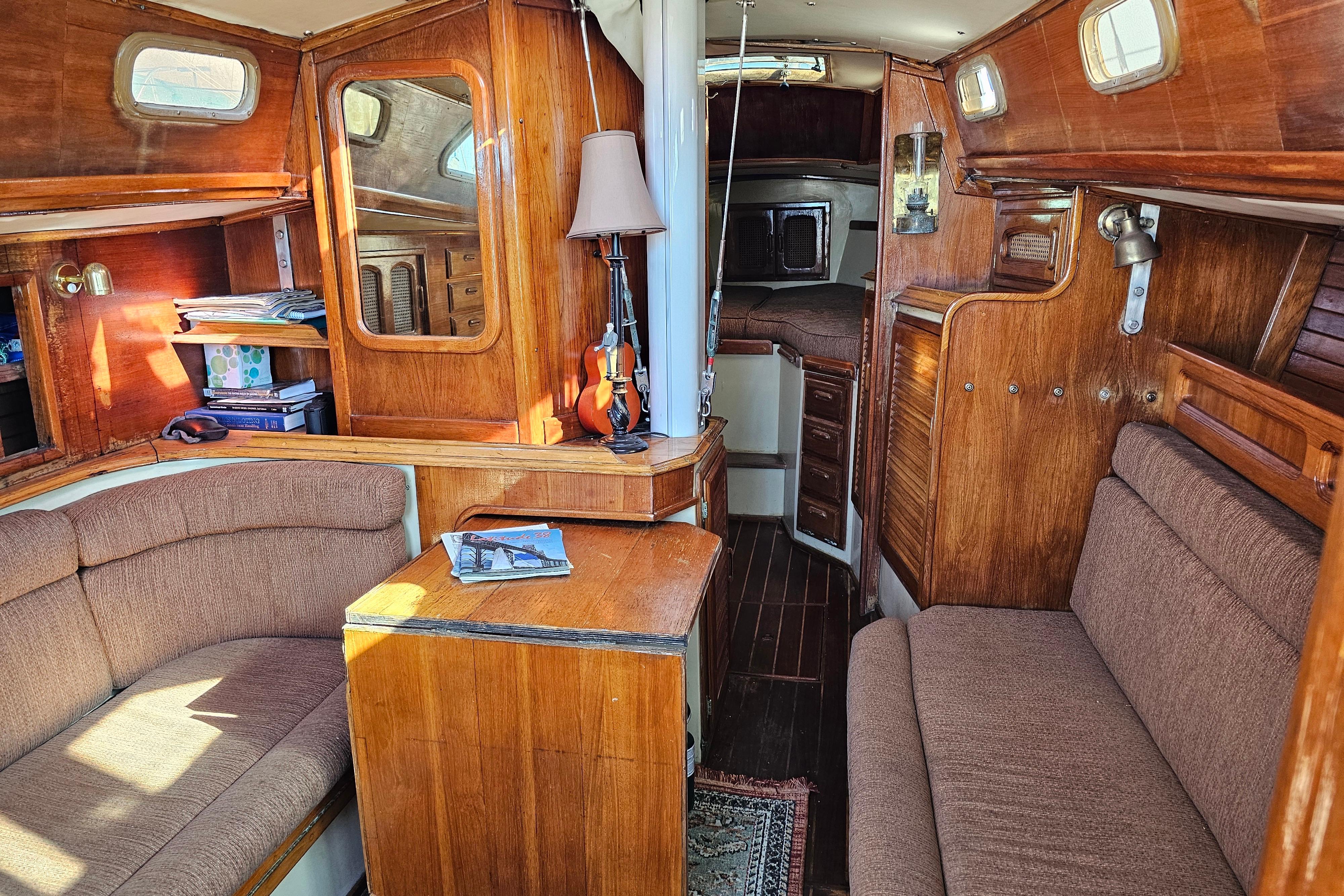 1978 Islander 36 sailboat interior with wood finish and cozy seating area.