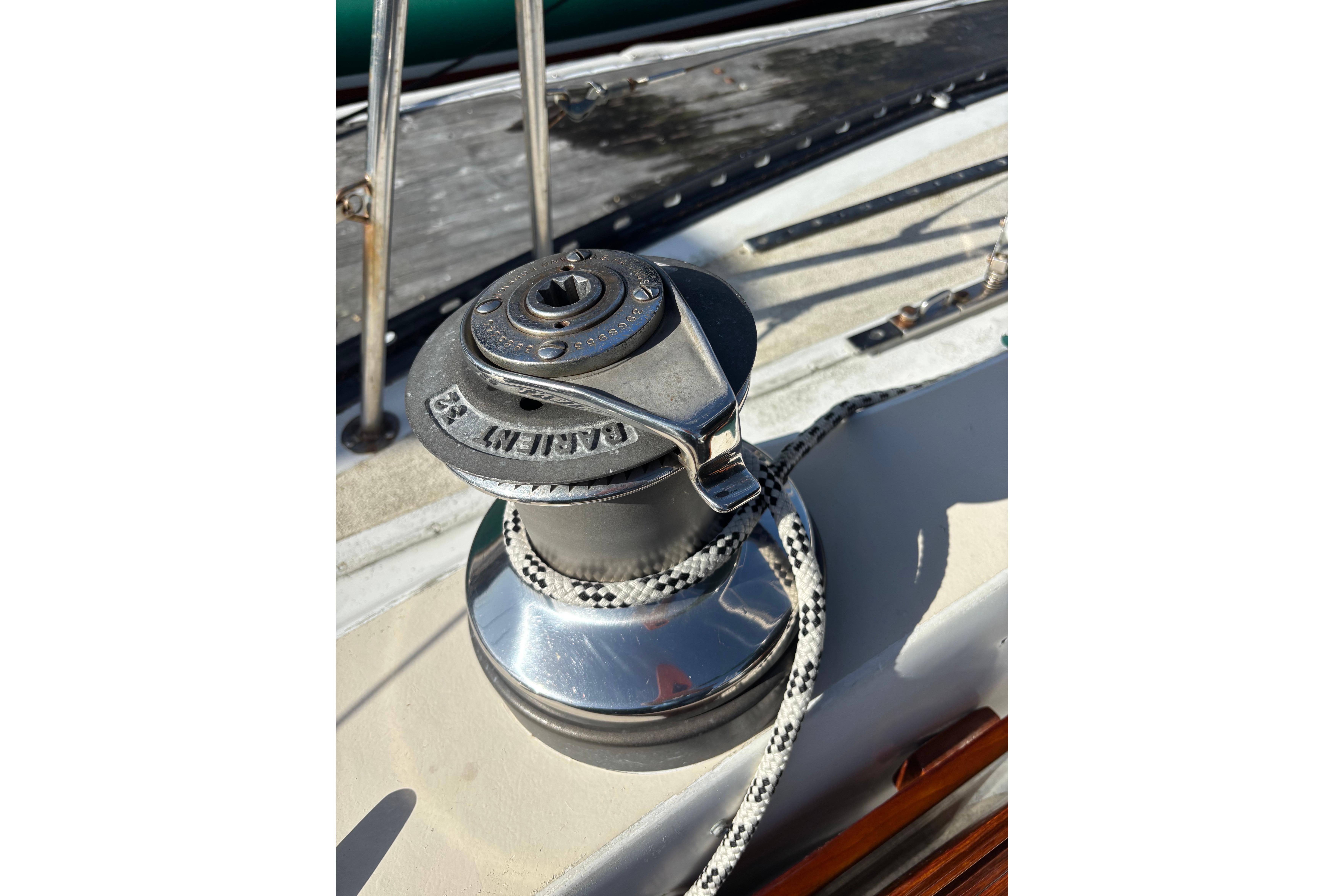 Winch on 1978 Islander 36 sailboat deck with rope and metal fittings.