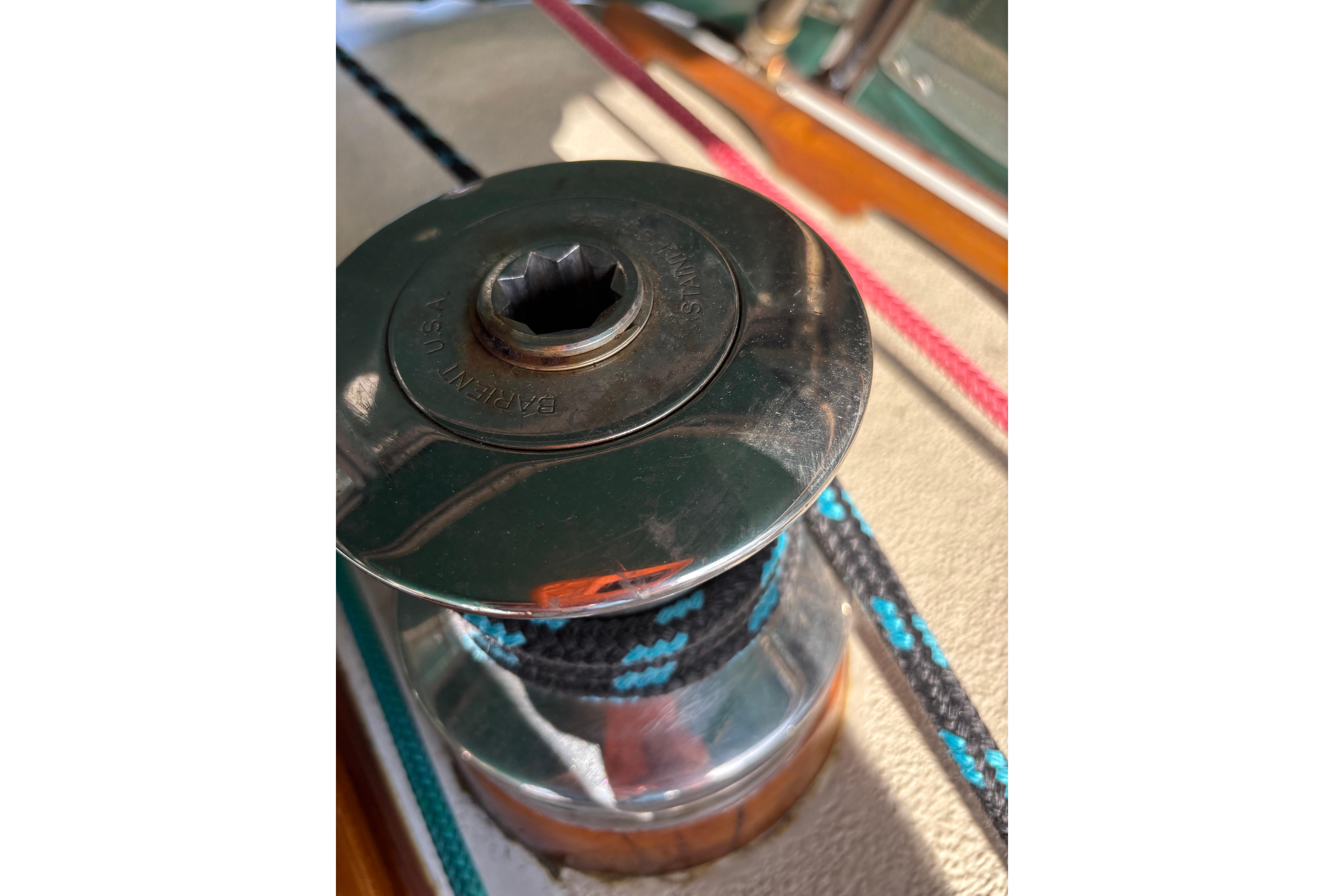 Winch on 1978 Islander 36 sailboat with colorful ropes.