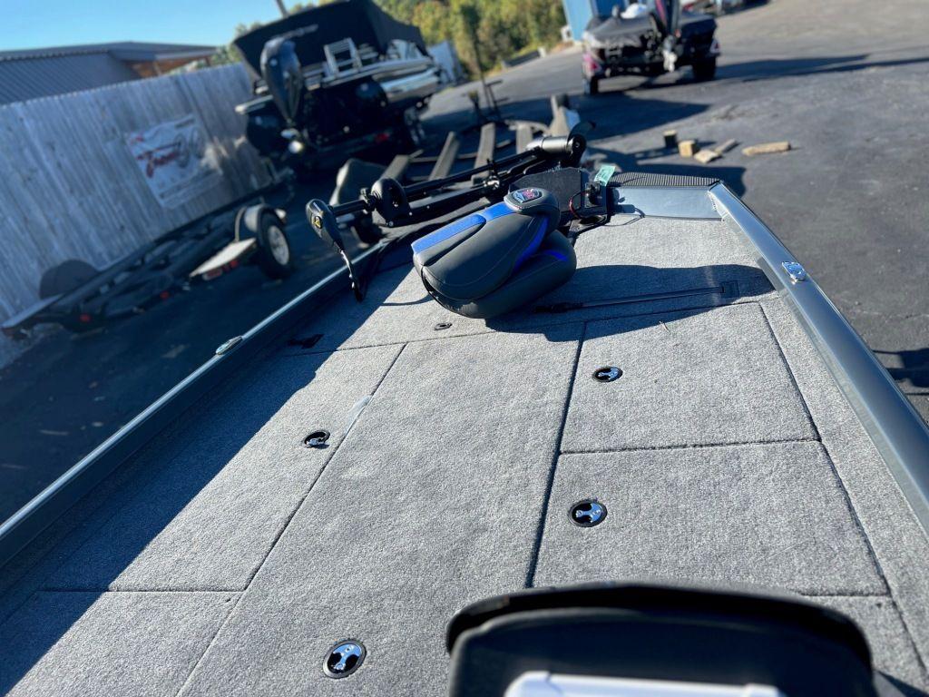 2023 Ranger RT198P boat deck with fishing equipment in a parking area.