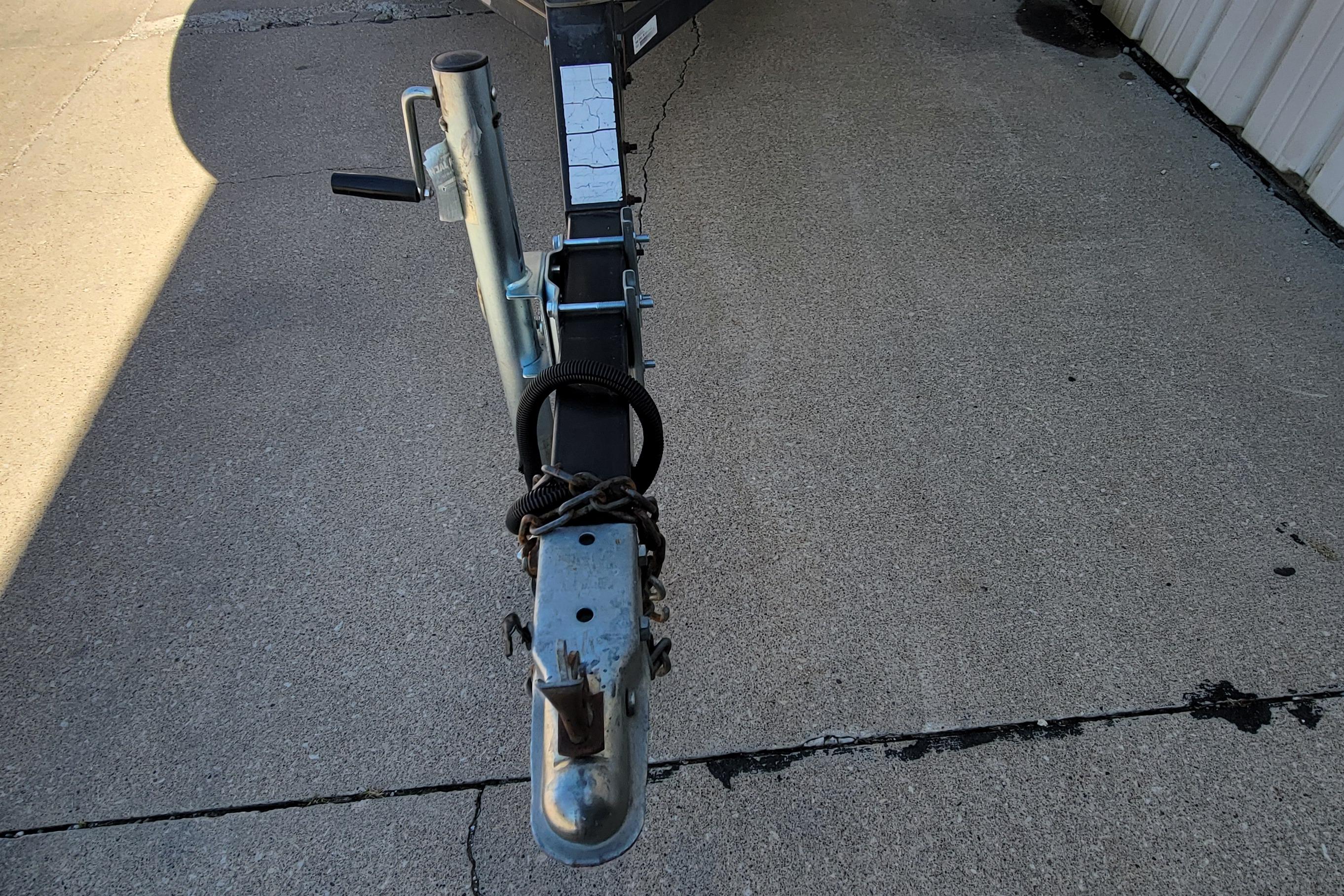 Trailer hitch of a 1997 Sea Nymph 168 DLX on concrete surface.