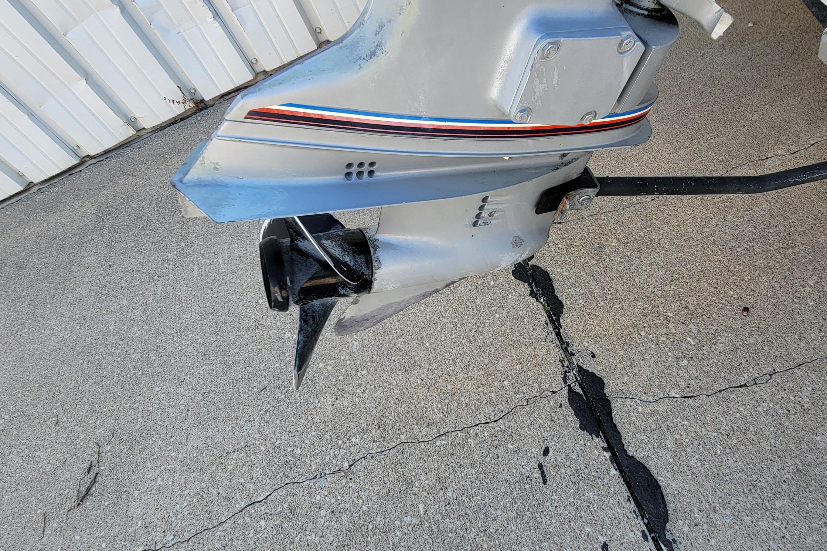 1997 Sea Nymph 168 DLX boat motor on concrete surface, showing propeller and lower unit.