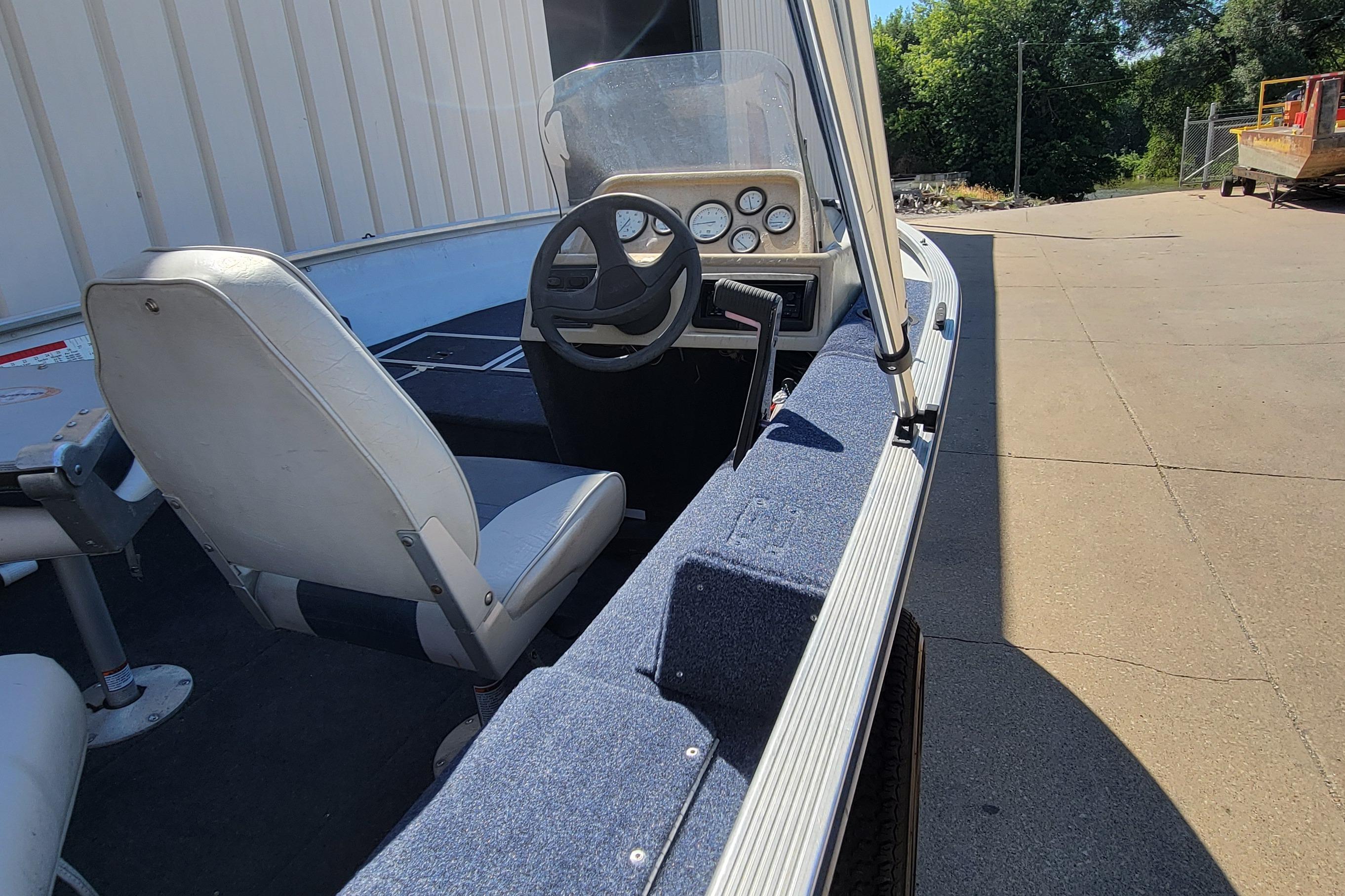 1997 Sea Nymph 168 DLX boat interior with steering wheel and seating.