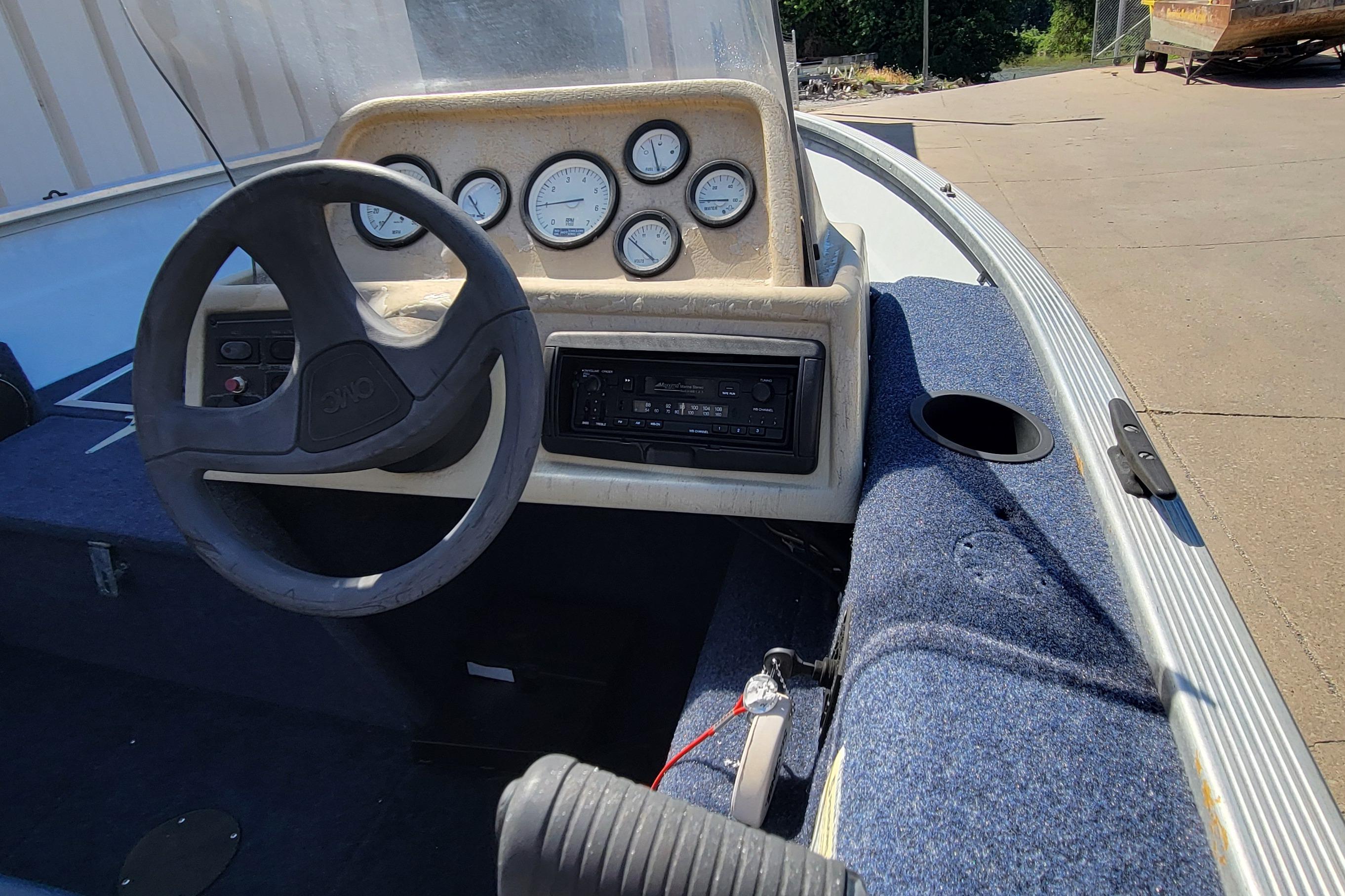 1997 Sea Nymph 168 DLX boat dashboard with steering wheel and gauges.
