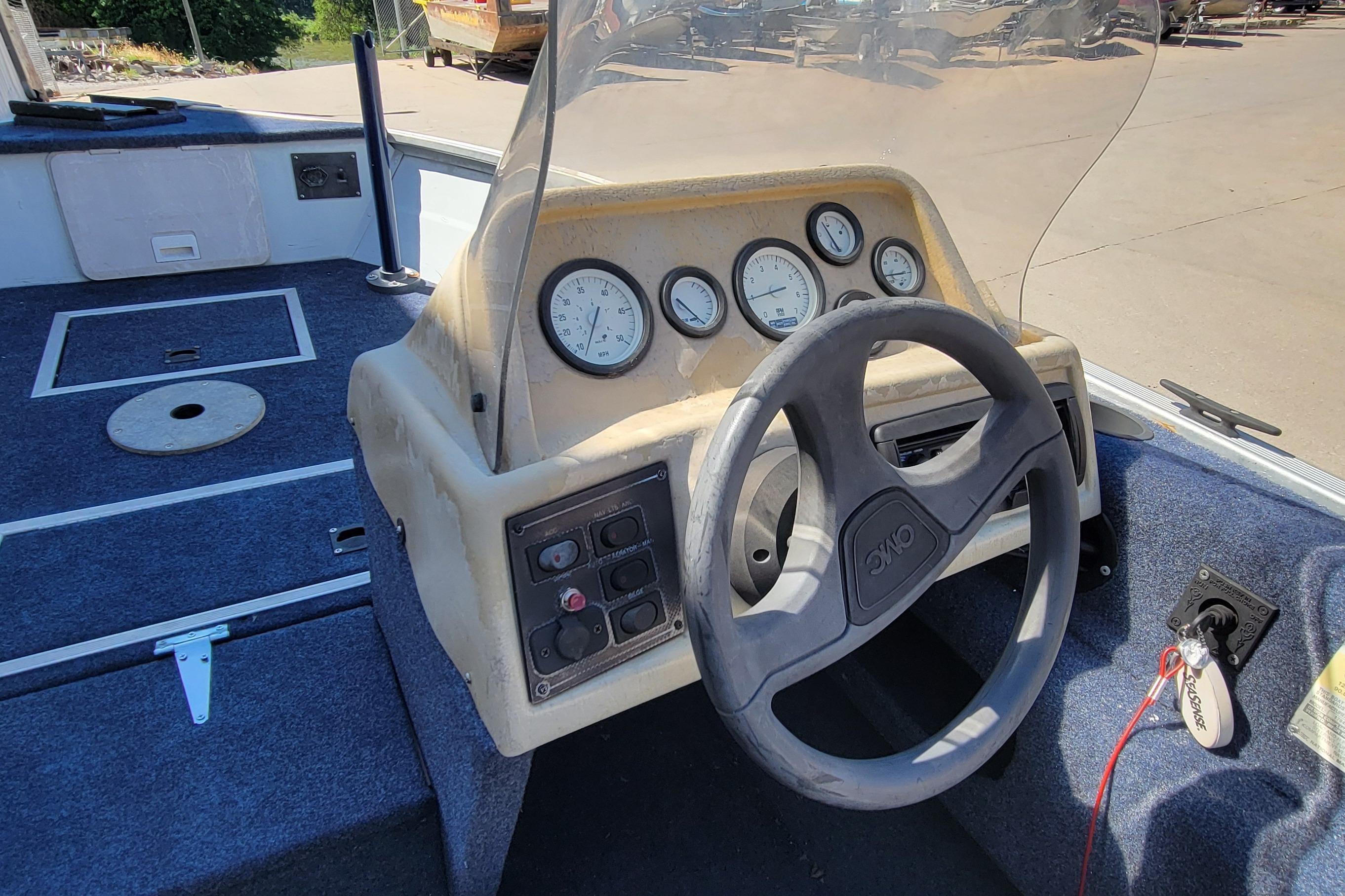 1997 Sea Nymph 168 DLX boat dashboard with steering wheel and gauges.