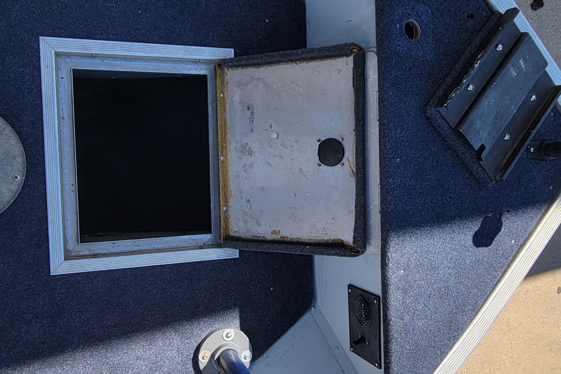 Open hatch on 1997 Sea Nymph 168 DLX boat deck, showing interior compartment.