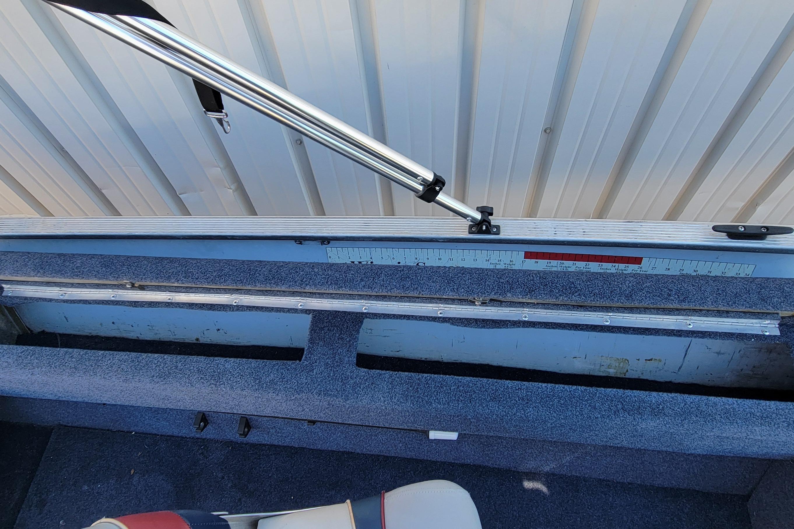 1997 Sea Nymph 168 DLX boat interior with measuring ruler and support pole.