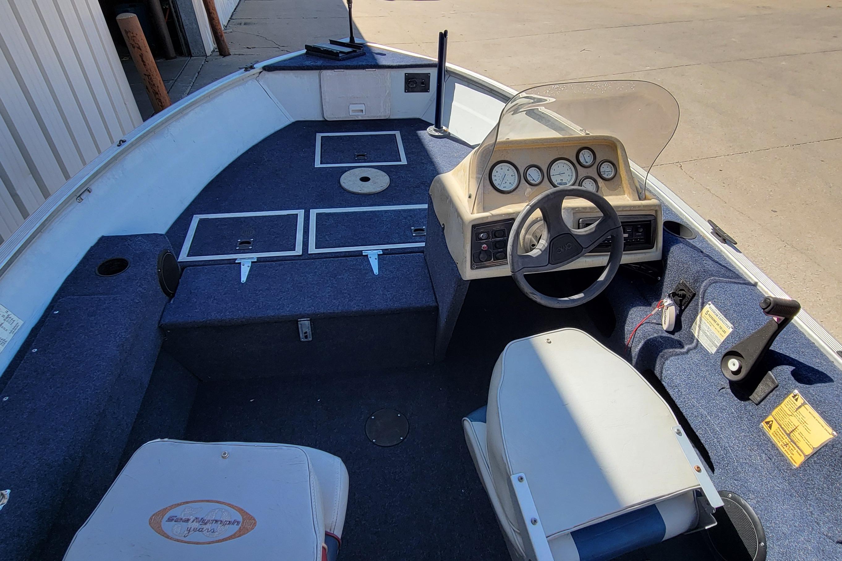 1997 Sea Nymph 168 DLX boat interior with steering console and seating.