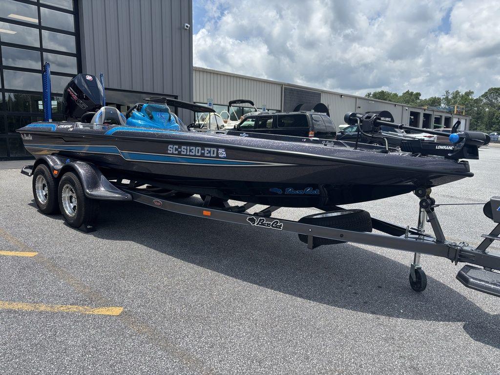 2023 Bass Cat Cougar FTD boat on trailer, parked outside a building.