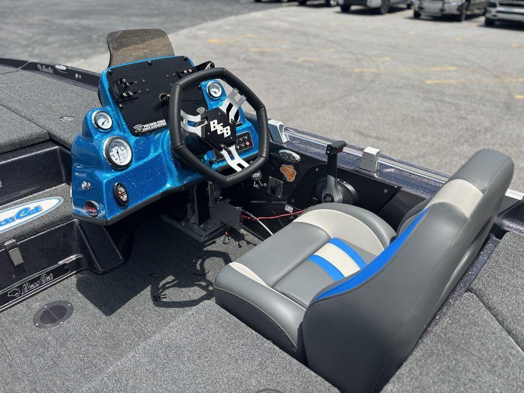 2023 Bass Cat Cougar FTD boat cockpit with blue dashboard and steering wheel.