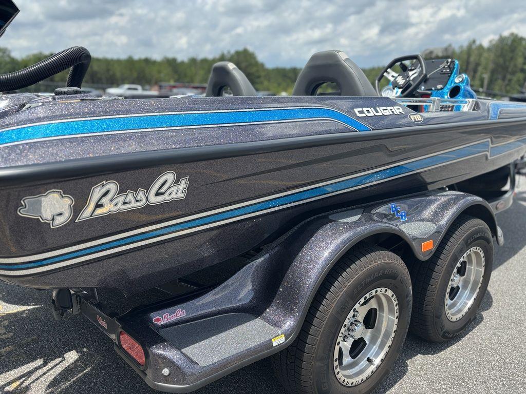 2023 Bass Cat Cougar FTD boat with blue accents on a trailer.