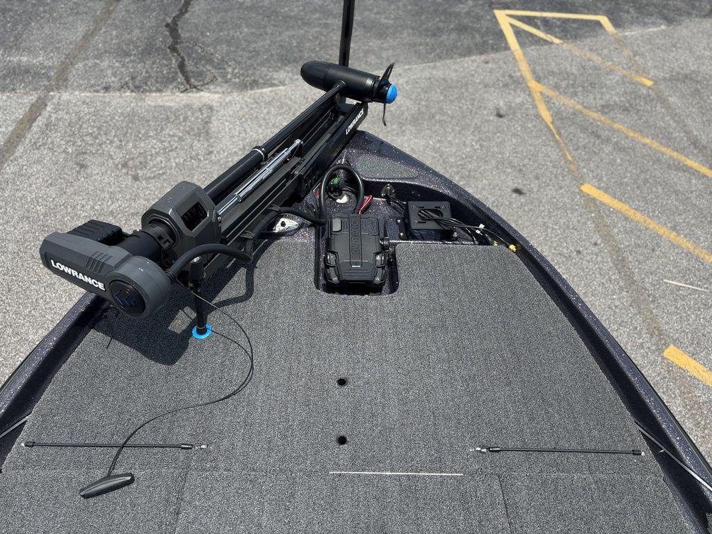 2023 Bass Cat Cougar FTD boat deck with Lowrance equipment, parked on asphalt.