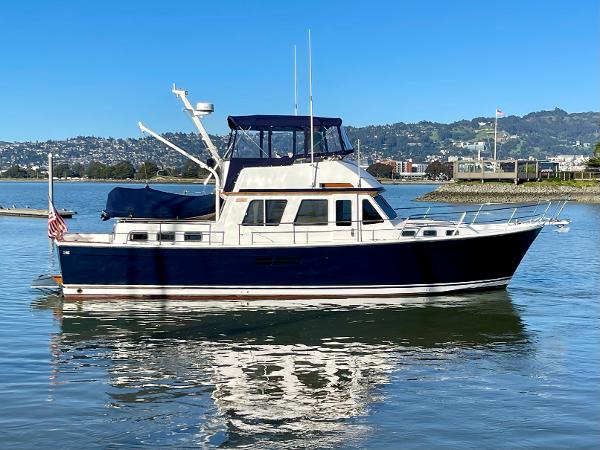 1997 Sabre Cockpit Motor Yacht on calm water, clear sky background.