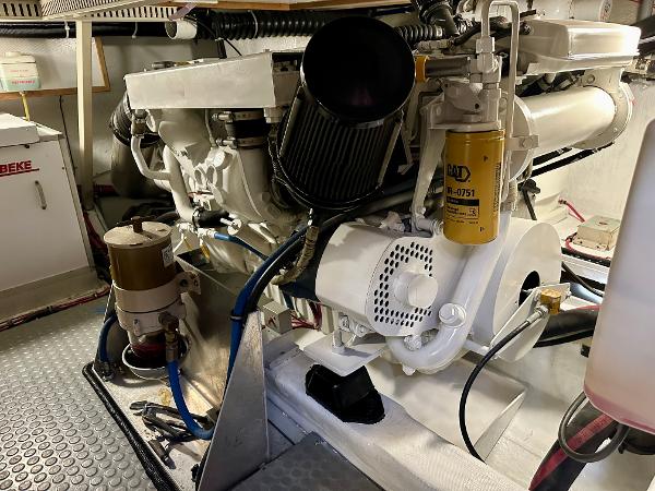 Engine room of a 1997 Sabre Cockpit Motor Yacht, showcasing mechanical components and filters.