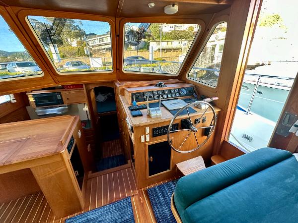 1997 Sabre Cockpit Motor Yacht interior with wooden dashboard and steering wheel.